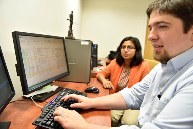 PhD student works with a professor on a project.