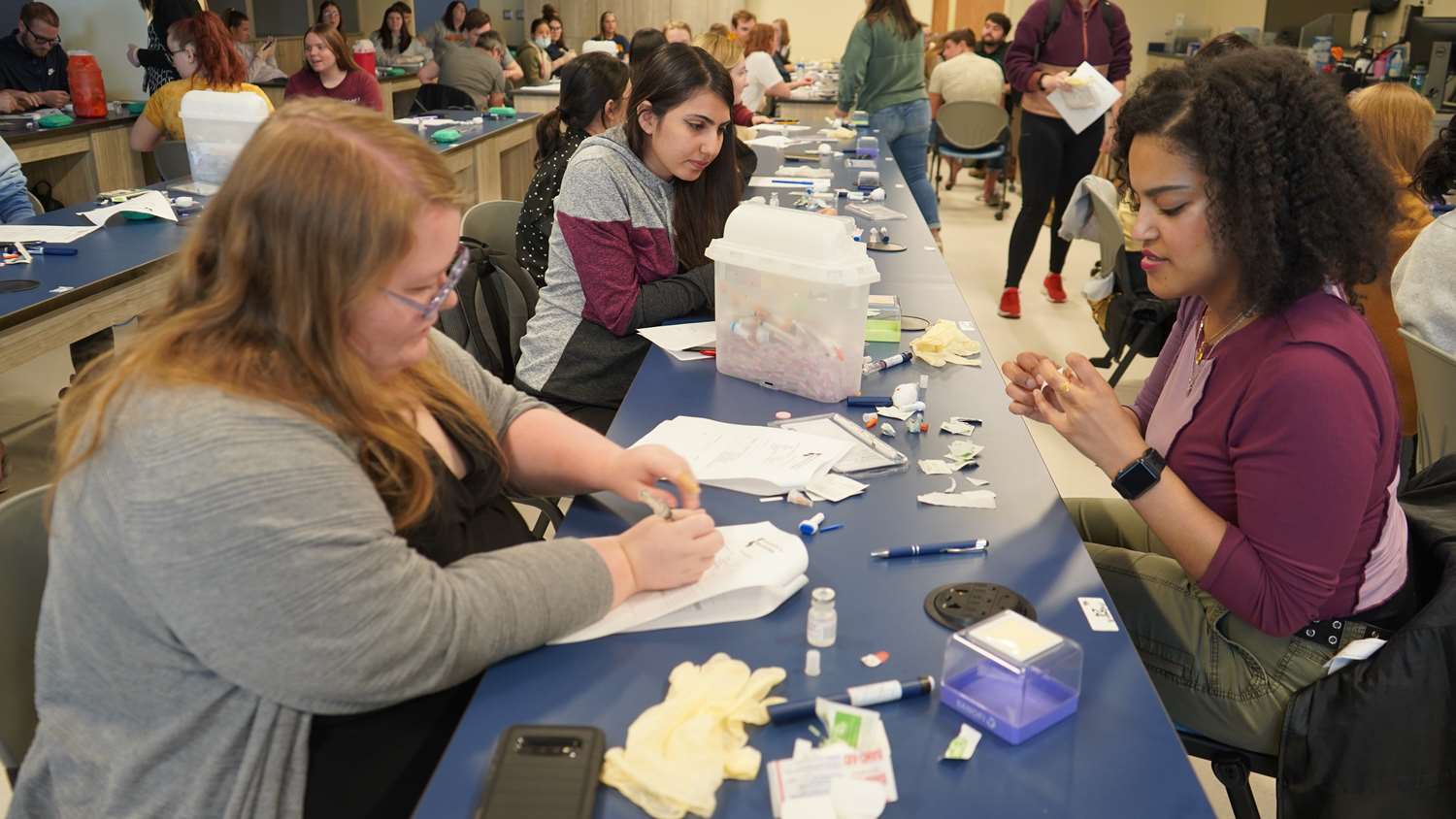 The Compounding Lab shows lab style tables where students are seated and participating in glucose training.